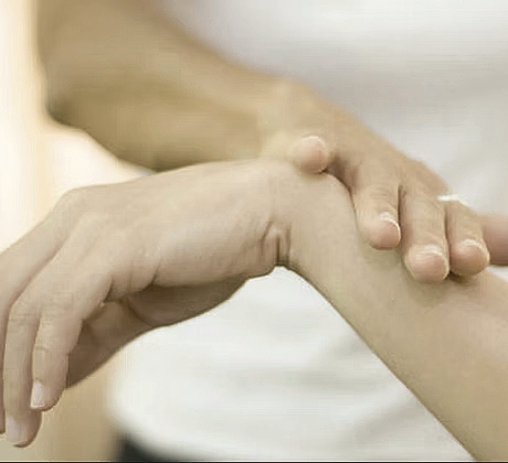 Chinese Medicine and Breema 4 Practitioner hand on a client wrist during session of Neuro Emotional Technique
